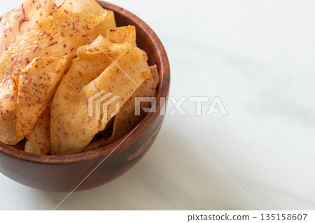 Taro Chips - fried or baked sliced taro 135158607