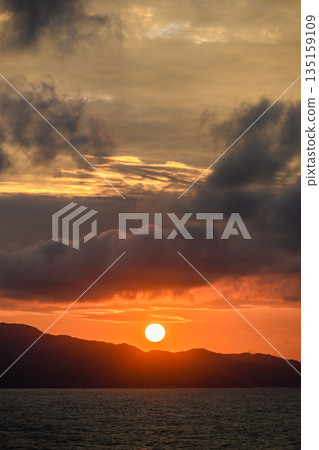 Big sun setting over the sea 135159109