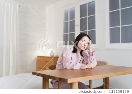 Young woman with a headache Lifestyle image 135159159