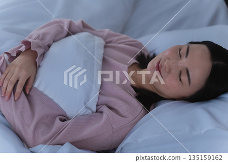 Young woman sleeping in bed Lifestyle image Young woman sleeping in bed Lifestyle image 135159162