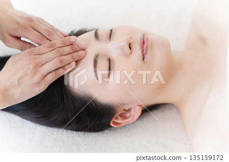 A young woman receiving treatment from an esthetician. Beauty image A young woman receiving treatment from an esthetician. Beauty image 135159172
