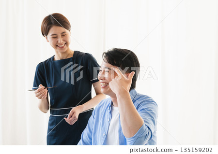 A young man having his eyebrows done by a makeup artist Beauty image A young man having his eyebrows done by a makeup artist Beauty image 135159202