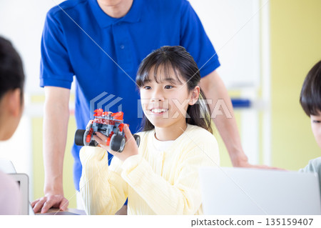 Elementary school students learning in a programming class 135159407