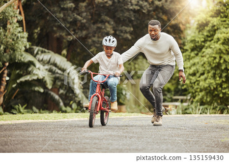 Family, father teaching child cycling in park with bicycle and helmet for safety, learning and help. Support, motivation and trust, black man with boy outdoor and learn bike riding with mockup space 135159430