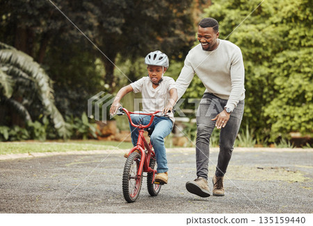 Black family, father teaching child cycling in park with bicycle and helmet for safety, learning and help. Support, motivation and trust, man with boy outdoor and learn bike riding with mockup space 135159440