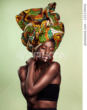 Beauty, black woman fashion and cosmetics with African head wrap and makeup in studio. Isolated, green background and young female person with a traditional hair scarf with confidence and culture 135159442