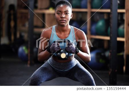 Fitness, kettlebell squat or portrait of black woman in training, workout or bodybuilding exercise for grip. Body builder, power or strong sports athlete with at gym to start lifting heavy weights Fitness, kettlebell squat or portrait of black woman in training, workout or bodybuilding exercise for grip. Body builder, power or strong sports athlete with at gym to start lifting heavy weights 135159444