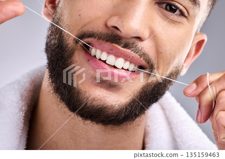 Face, man and flossing teeth for dental health in studio isolated on a white background. Portrait, floss and male model cleaning tooth for oral wellness, hygiene and healthy gums for fresh breath. 135159463