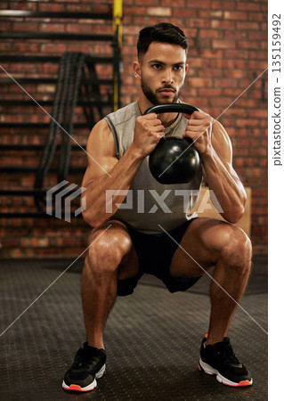 Bodybuilder, fitness and man with kettle bell in gym for exercise, strength training and workout. Sports, challenge and serious male person squat with weights for wellness, healthy body and muscles Bodybuilder, fitness and man with kettle bell in gym for exercise, strength training and workout. Sports, challenge and serious male person squat with weights for wellness, healthy body and muscles 135159492
