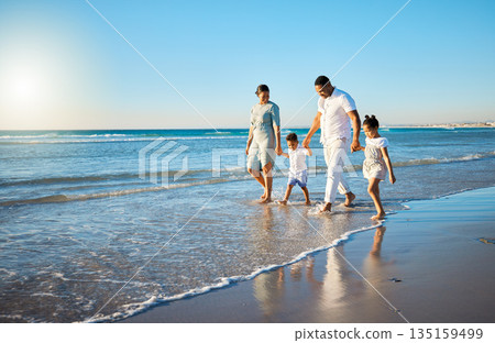 Family travel, beach walking and holding hands with mother, father and kids at ocean on holiday. Vacation and parent care with mockup in summer outdoor with mom, dad and children by sea having fun Family travel, beach walking and holding hands with mother, father and kids at ocean on holiday. Vacation and parent care with mockup in summer outdoor with mom, dad and children by sea having fun 135159499