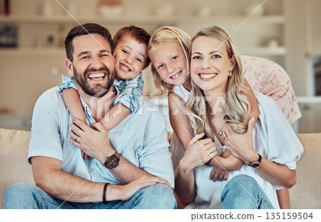 Portrait of parents, kids and smile on sofa for playful childhood, happiness and quality time in family home. Happy children, mother and father hug in living room for bonding, love and care together 135159504
