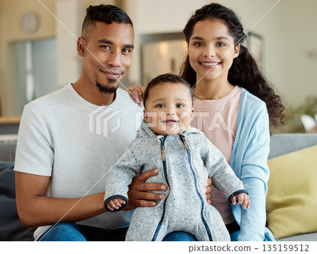 Family, smile and portrait of baby in home living room, bonding and having fun in house. Father, mother and face of child on sofa, relax with newborn and enjoying quality time together with happiness 135159512