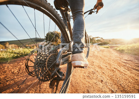 Feet, cycling and a man on a bike and dirt road for fitness, morning cardio or adventure in nature. Sports, tire and a person on a bicycle for a race, competition or exercise in the countryside Feet, cycling and a man on a bike and dirt road for fitness, morning cardio or adventure in nature. Sports, tire and a person on a bicycle for a race, competition or exercise in the countryside 135159591