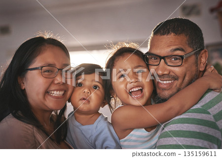 Portrait, laugh and happy family hug in a living room, excited and bonding in their home together. Face, children and parents in a lounge embrace, relax and laughing at funny, comedy and crazy joke Portrait, laugh and happy family hug in a living room, excited and bonding in their home together. Face, children and parents in a lounge embrace, relax and laughing at funny, comedy and crazy joke 135159611