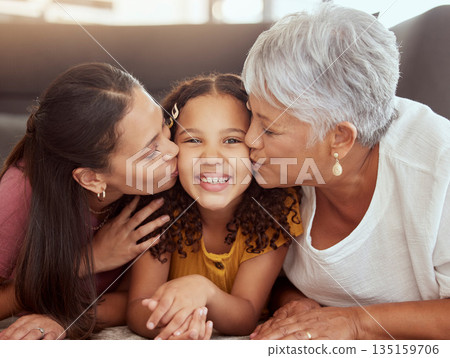 Portrait, mom and and kiss with grandmother and kid on floor of living room for bonding, smile and love. Happiness, trust and generations with women and girl in family home for solidarity and support Portrait, mom and and kiss with grandmother and kid on floor of living room for bonding, smile and love. Happiness, trust and generations with women and girl in family home for solidarity and support 135159706