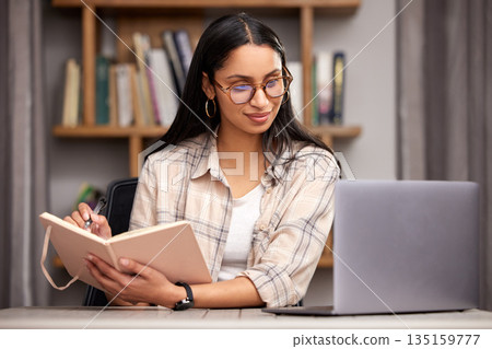Laptop, notebook and learning with a student woman in a university library to study for a final exam. Technology, education and diary with a young female college pupil reading research material Laptop, notebook and learning with a student woman in a university library to study for a final exam. Technology, education and diary with a young female college pupil reading research material 135159777