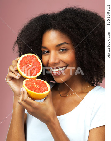 Grapefruit, happy and portrait of woman in studio isolated on a pink background, citrus detox or natural wellness. Face, fruits and african female model with vegan beauty, vitamin c and healthy diet 135159811