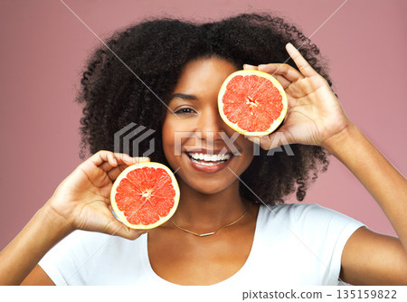 Grapefruit, smile and face portrait of black woman in studio isolated on a pink background. Natural, fruit and African female model with vegan nutrition, vitamin c or healthy diet, food or wellness. Grapefruit, smile and face portrait of black woman in studio isolated on a pink background. Natural, fruit and African female model with vegan nutrition, vitamin c or healthy diet, food or wellness. 135159822