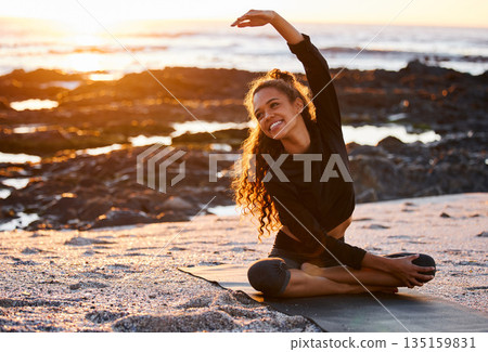 Woman, beach yoga and sunset with smile, stretching and peace of mind in summer sunshine on sand. Girl, zen meditation and mindfulness for health, wellness or exercise by ocean, outdoor and happiness 135159831
