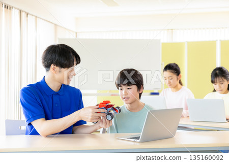 Boy learning in programming class Boy learning in programming class 135160092