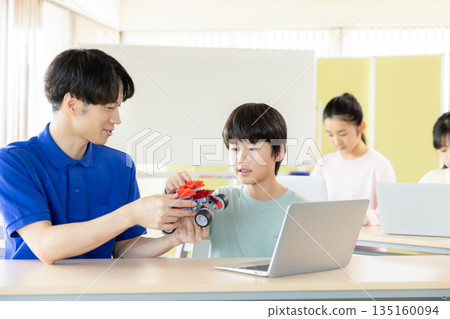 Boy learning in programming class Boy learning in programming class 135160094