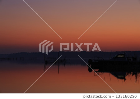 Morning glow reflected on the water surface Morning glow reflected on the water surface 135160250