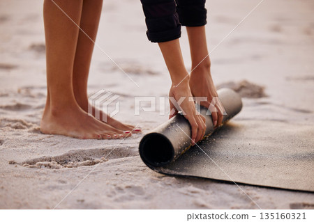 Woman, yoga and beach with hand and feet for rolling mat with clean wellness or fitness. Female person, meditation and yogi on seashore with hands in the outdoor for start in the morning and pilates. Woman, yoga and beach with hand and feet for rolling mat with clean wellness or fitness. Female person, meditation and yogi on seashore with hands in the outdoor for start in the morning and pilates. 135160321