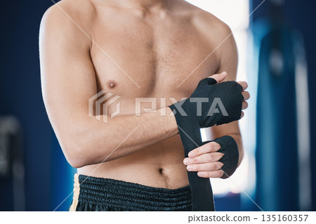 Sports, boxing and man wrap hands in gym for training, workout and exercise for mma fight. Fitness, body builder and male athlete with bandage prepare for boxer competition, practice and performance 135160357