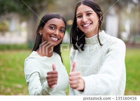 Young women, thumbs up and university students happy for education or yes for academic study or success portrait and on mock up. Agreement, female scholars and smile or achieve in new york campus Young women, thumbs up and university students happy for education or yes for academic study or success portrait and on mock up. Agreement, female scholars and smile or achieve in new york campus 135160416