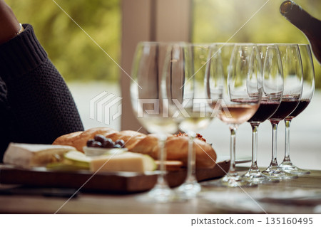 Wine tasting, cheese platter and winery restaurant with alcohol and glass for customer. Waiter, drink and sommelier with bottle for wines and food pairing in a fine dining and luxury experience 135160495