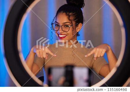 Influencer woman, ring light and portrait with smile, pointing and beauty on live stream, broadcast or web video. Girl, review or online entrepreneur with happiness, makeup or talking on social media Influencer woman, ring light and portrait with smile, pointing and beauty on live stream, broadcast or web video. Girl, review or online entrepreneur with happiness, makeup or talking on social media 135160498