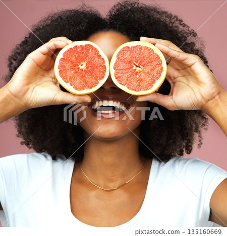 Grapefruit, happy and black woman covering her eyes in studio isolated on a pink background. Funny, fruit and African female model with vegan nutrition, vitamin c or healthy diet, food and wellness. 135160669