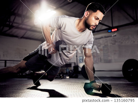 Fitness, push up and man exercise with dumbbells at gym for training workout with focus. Serious male athlete or bodybuilder with weights for strong muscle, power or motivation for hard work on floor 135160795