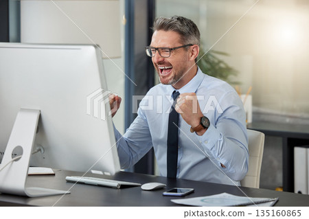 Happy, businessman and fist in celebration for winning, success or promotion by desk at office. Man employee in joy for win, achievement or bonus on computer in sale, discount or prize at workplace Happy, businessman and fist in celebration for winning, success or promotion by desk at office. Man employee in joy for win, achievement or bonus on computer in sale, discount or prize at workplace 135160865