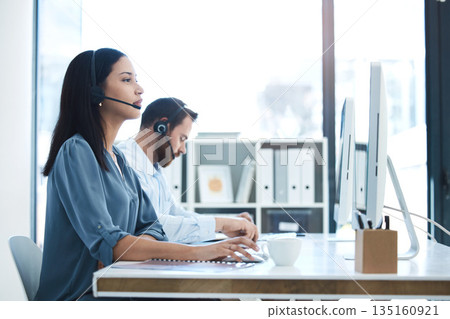 Call center, people and team in customer service, support or telemarketing on computer at the office. Woman and man consultant, agent or virtual assistant working for online agency at the workplace Call center, people and team in customer service, support or telemarketing on computer at the office. Woman and man consultant, agent or virtual assistant working for online agency at the workplace 135160921