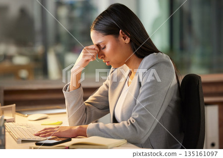 Headache, stress and sad business woman in night office for burnout, fatigue or mental health problem. Crisis, pain and depressed or tired professional person at desk for mistake, depression or fail 135161097