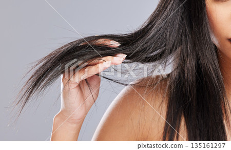 Hair in hands, damage and woman in studio with worry for split ends, haircare crisis and weak strand. Beauty, hairdresser and closeup of upset female person with frizz problem on gray background Hair in hands, damage and woman in studio with worry for split ends, haircare crisis and weak strand. Beauty, hairdresser and closeup of upset female person with frizz problem on gray background 135161297