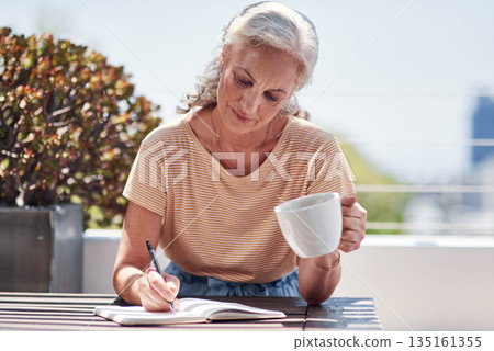 Writing, book and an old woman author sitting outdoor in summer for inspiration as a writer. Idea, planning and a senior female pensioner drinking coffee while using a pen to write in her diary 135161355