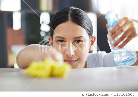 Spray, table and cleaning with a woman maid using disinfectant to remove bacteria in a home. Safety, surface and hygiene with a female housekeeping cleaner working in a house living room for service Spray, table and cleaning with a woman maid using disinfectant to remove bacteria in a home. Safety, surface and hygiene with a female housekeeping cleaner working in a house living room for service 135161505