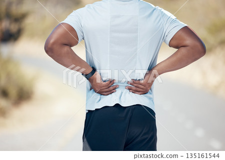 Back pain, fitness and man on the road, training and exercise with muscle tension, strain and emergency. Male person, guy and athlete with joint injury, outdoor and accident with a health problem 135161544
