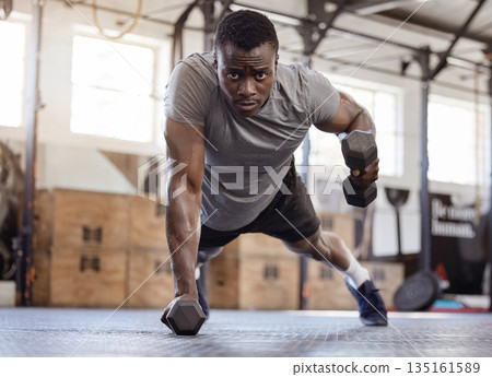 Dumbbells, push up and exercise with a black man at gym for fitness, training workout and strong muscle. Serious African athlete or bodybuilder person with weights for power, focus and performance 135161589