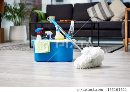 Cleaning, bacteria and mop on the floor of a living room in a home for hygiene or service during housework. Product, detergent and safety with supplies in a bucket ready to clean a house for service 135161811