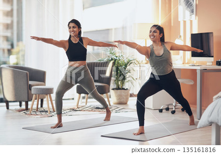 Friends, yoga and women exercise together in a house for health, balance or wellness. Happy Indian sisters or female family in a home for stretching workout, warrior pose and fitness with a partner Friends, yoga and women exercise together in a house for health, balance or wellness. Happy Indian sisters or female family in a home for stretching workout, warrior pose and fitness with a partner 135161816
