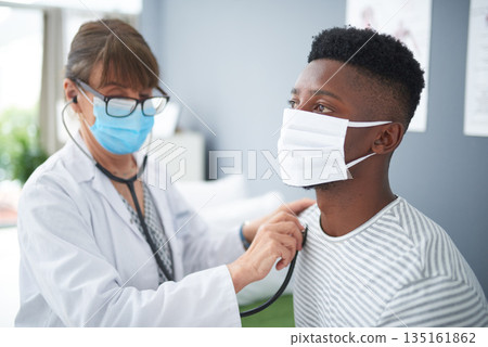 Doctor, exam and woman with patient listening to heart, breathing or medical healthcare test for covid in hospital. Clinic, black man and corona mask or sick person, check health with stethoscope Doctor, exam and woman with patient listening to heart, breathing or medical healthcare test for covid in hospital. Clinic, black man and corona mask or sick person, check health with stethoscope 135161862