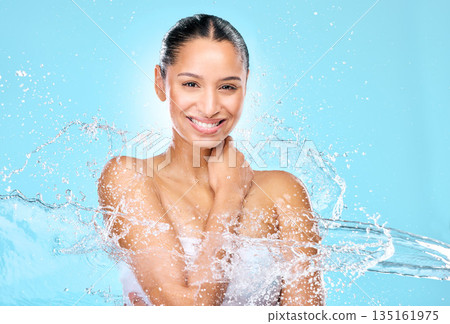 Water, splash and beauty with portrait of woman in studio for hygiene, shower and skincare. Wellness, cleaning and fresh with face of female model on blue background for spa, cosmetics and liquid 135161975