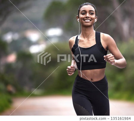 Running in nature, woman with earphones and fitness, mockup space and smile on healthy workout on path. Exercise, health and wellness, happy girl runner on forest path with music and training mindset Running in nature, woman with earphones and fitness, mockup space and smile on healthy workout on path. Exercise, health and wellness, happy girl runner on forest path with music and training mindset 135161984