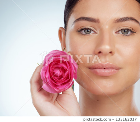 Skincare, face and woman with rose in studio isolated on a white background. Portrait, natural flower and serious female model with pink floral plant for makeup cosmetics, beauty treatment or organic Skincare, face and woman with rose in studio isolated on a white background. Portrait, natural flower and serious female model with pink floral plant for makeup cosmetics, beauty treatment or organic 135162037