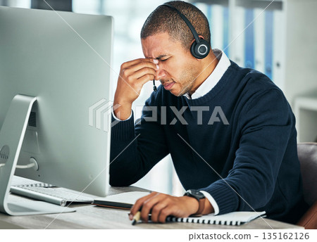 Stress, call center and a man with a headset at computer for customer service problem. African person consultant at pc with headache for telemarketing mistake, crm support and help desk or sales fail Stress, call center and a man with a headset at computer for customer service problem. African person consultant at pc with headache for telemarketing mistake, crm support and help desk or sales fail 135162126