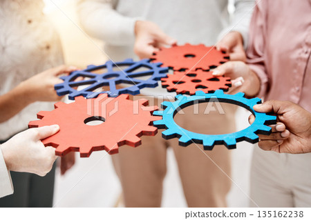 Professional, group and hands with gears for a collaboration in a meeting for support at a company. Teamwork, strategy and corporate employees with a partnership for a common goal for a project. 135162238