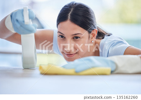 Woman, housekeeper and detergent for cleaning table, hygiene or bacteria and germ removal at home. Female person, cleaner or maid spraying and wiping furniture or surface for dust, dirt or stain Woman, housekeeper and detergent for cleaning table, hygiene or bacteria and germ removal at home. Female person, cleaner or maid spraying and wiping furniture or surface for dust, dirt or stain 135162260